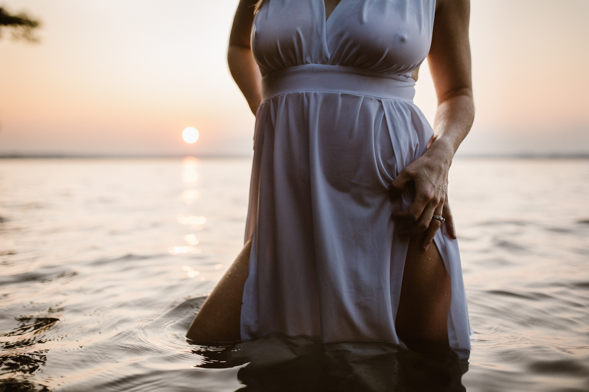 Captivating woman in an intimate lake session during a summer sunset.